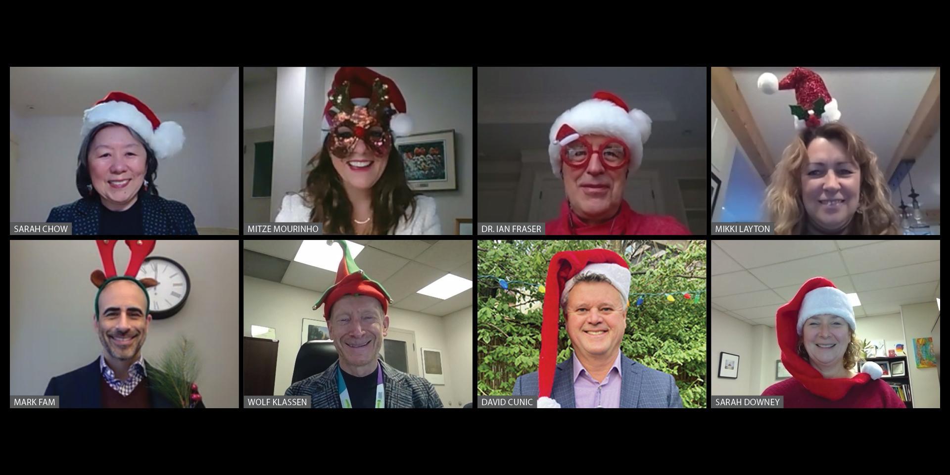 executive team all wearing holiday hats 