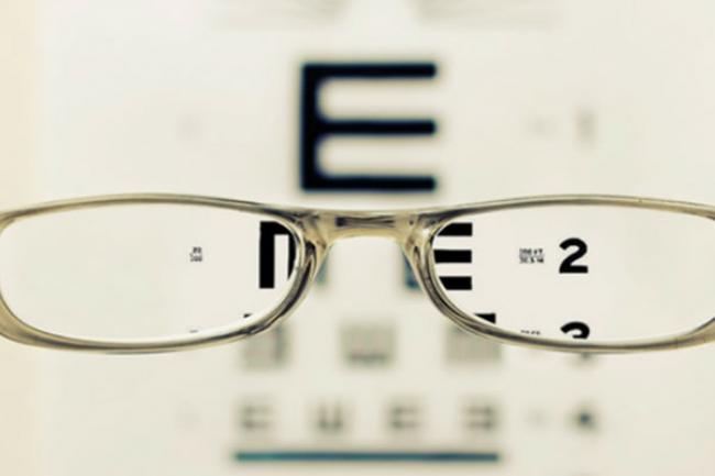eyeglasses in front of eye chart