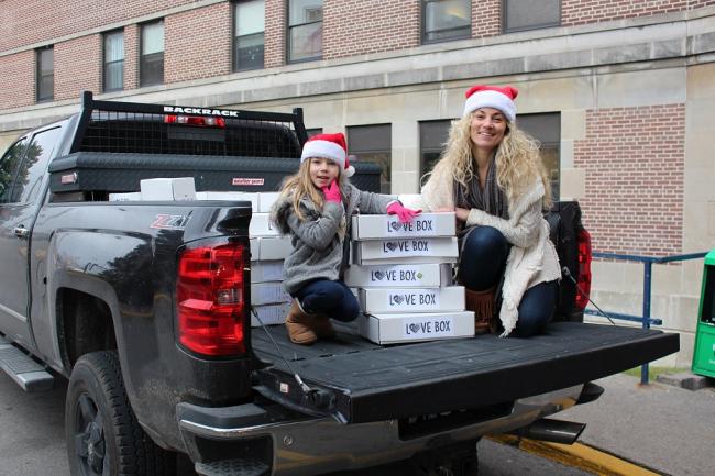 East Toronto resident Richelle Johnston and daughter Sydney, age six, unload Love Boxes at Michael Garron Hospital.
