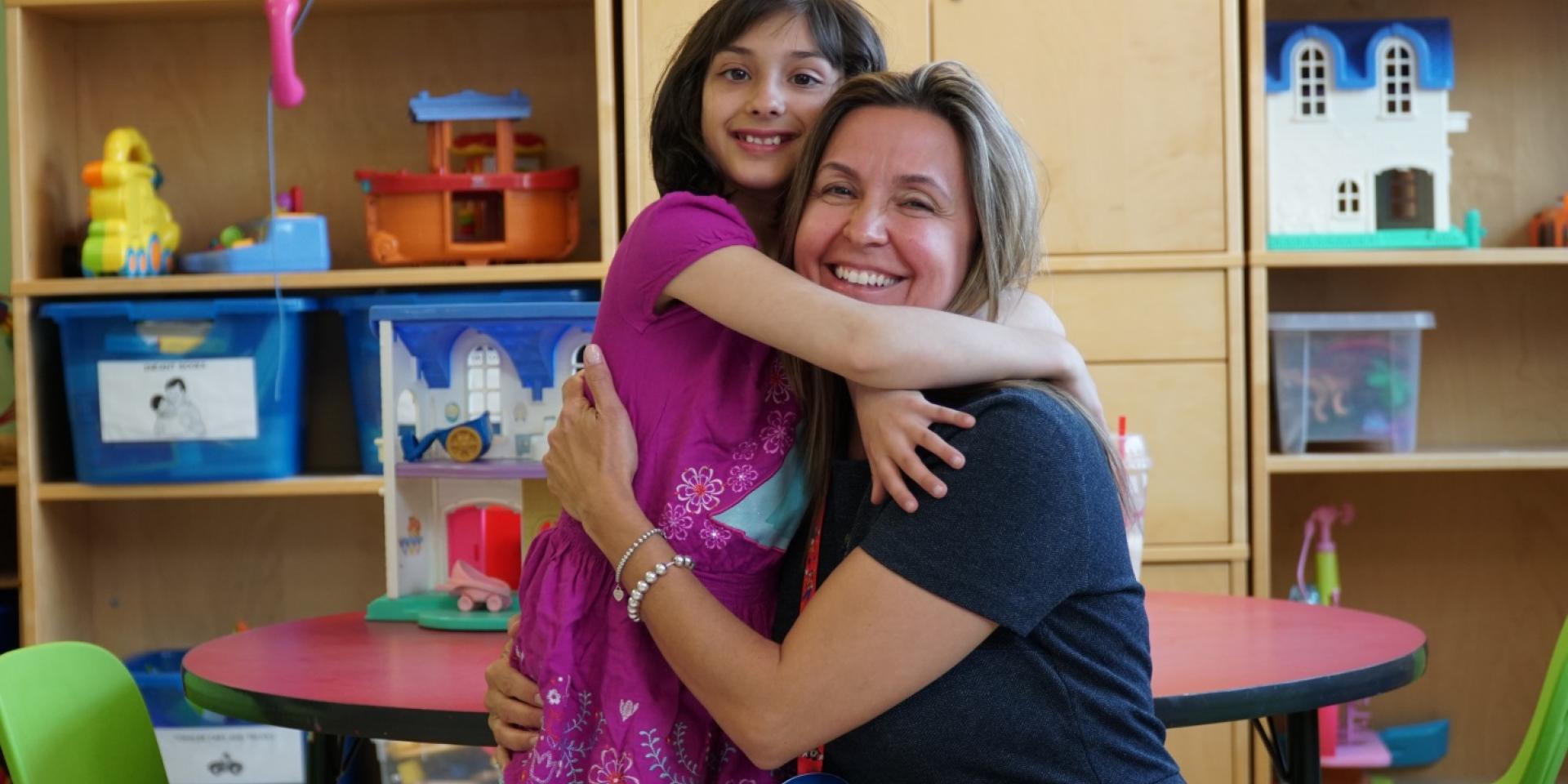 woman hugging little girl