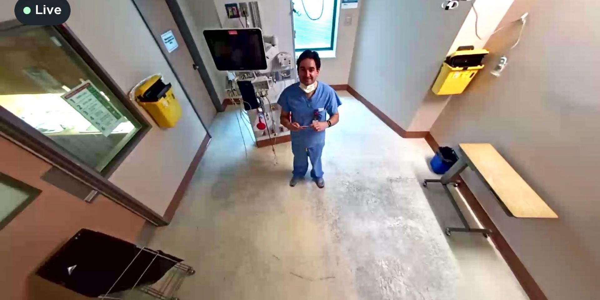 physician in room looking up at camera 