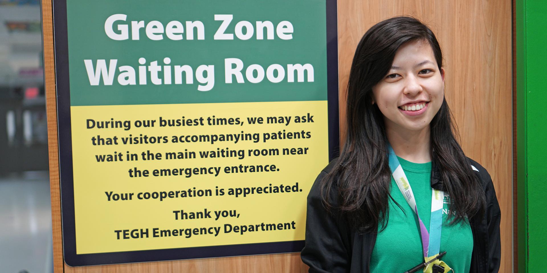 Woman standing in front of sign 