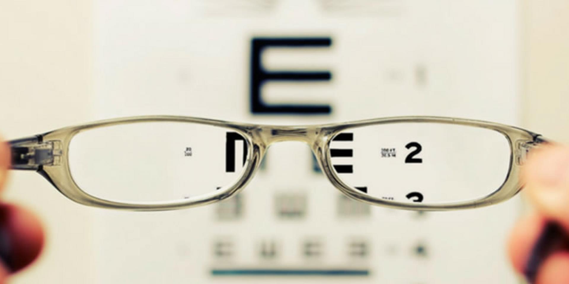 eyeglasses in front of eye chart