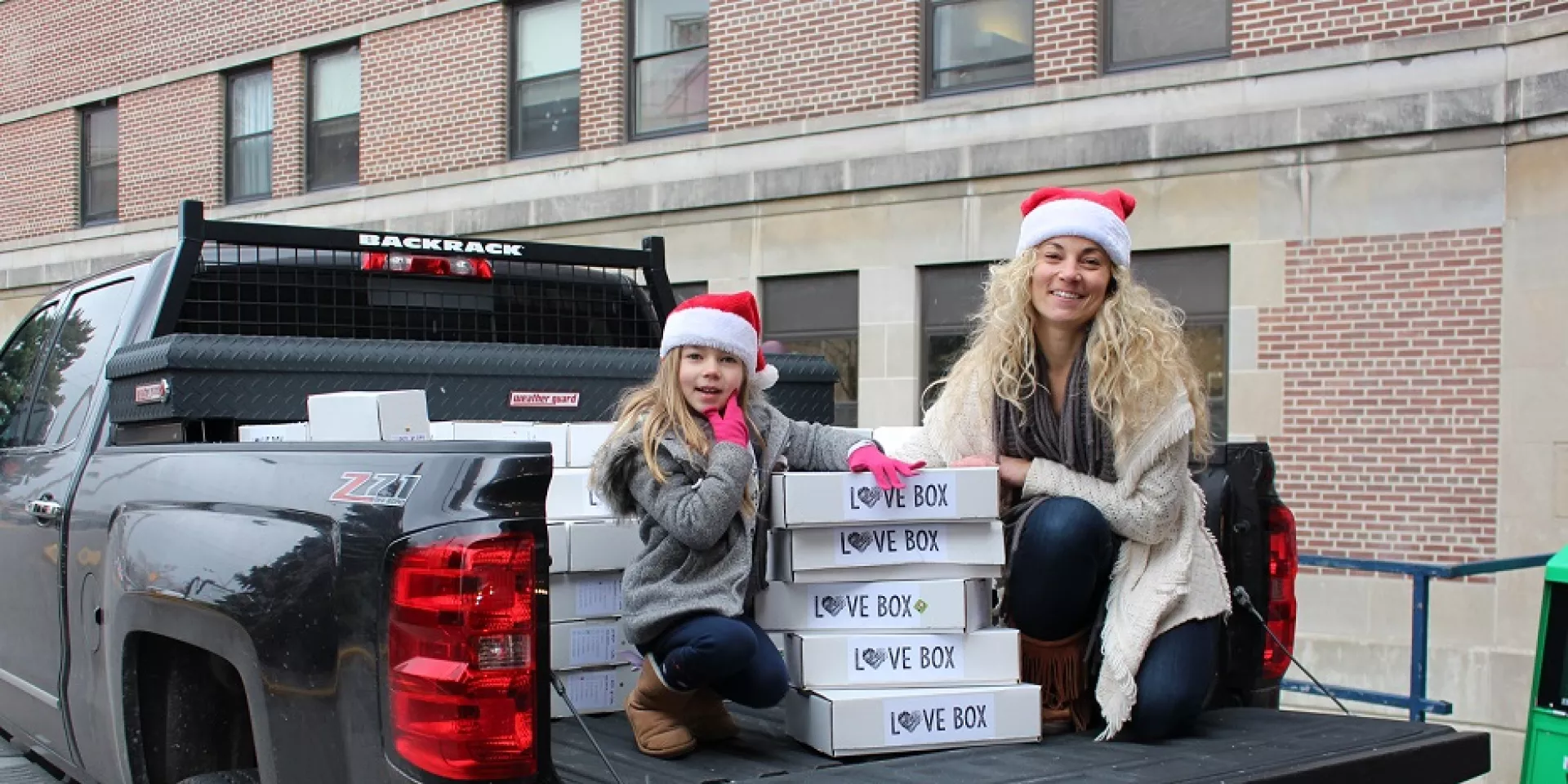 East Toronto resident Richelle Johnston and daughter Sydney, age six, unload Love Boxes at Michael Garron Hospital.