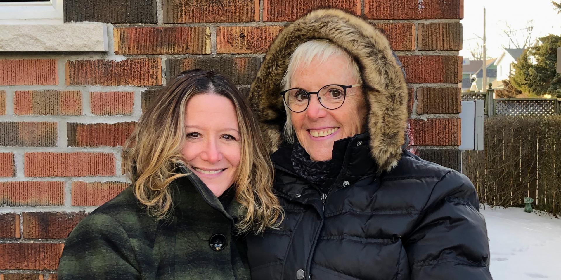 two woman standing outside 