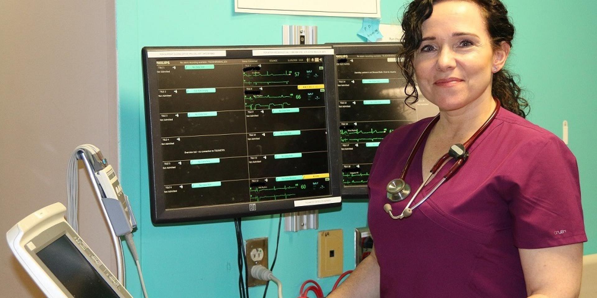 Nurse standing in front of monitor 