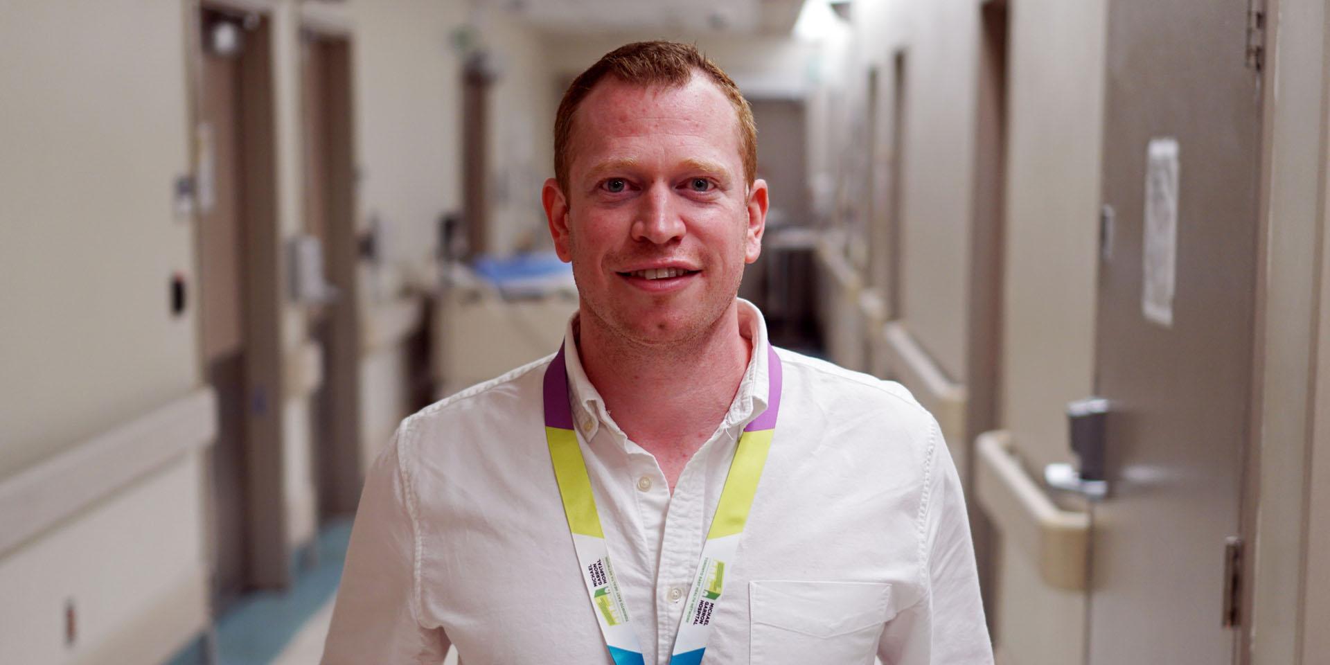 man standing in hallway facing camera