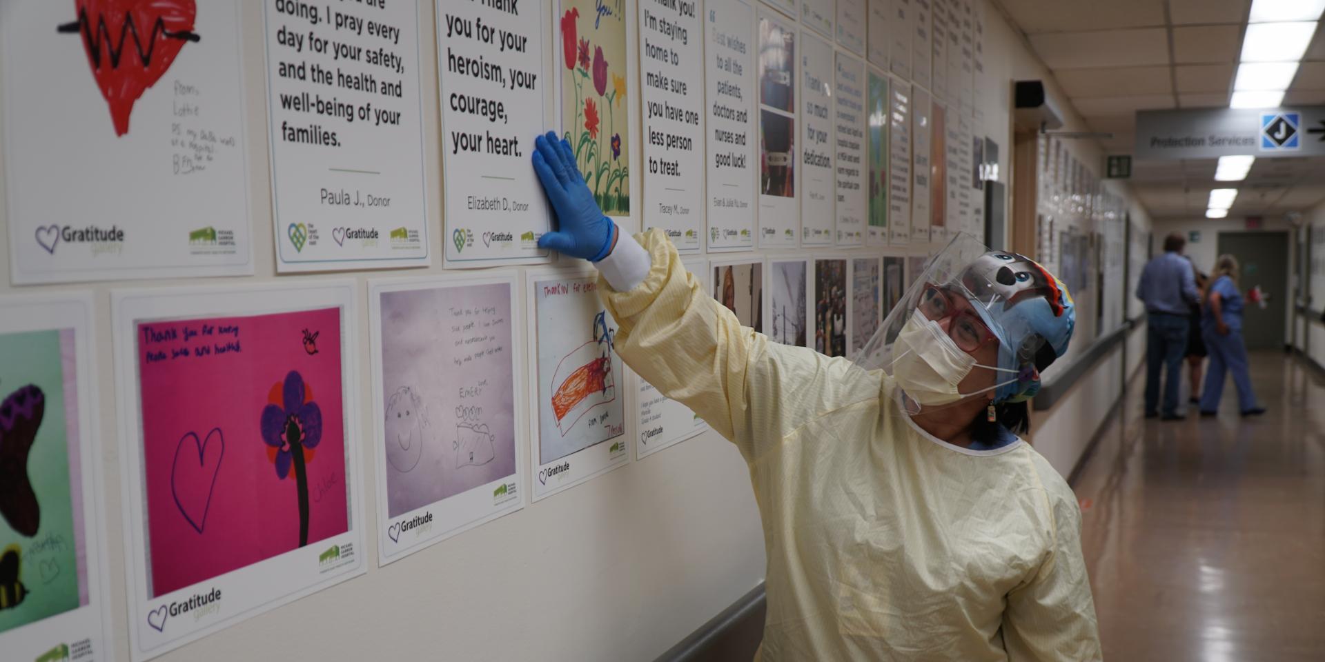 Ruby Quiambao, a Registered Nurse at Michael Garron Hospital, reads notes in our Gratitude Gallery.