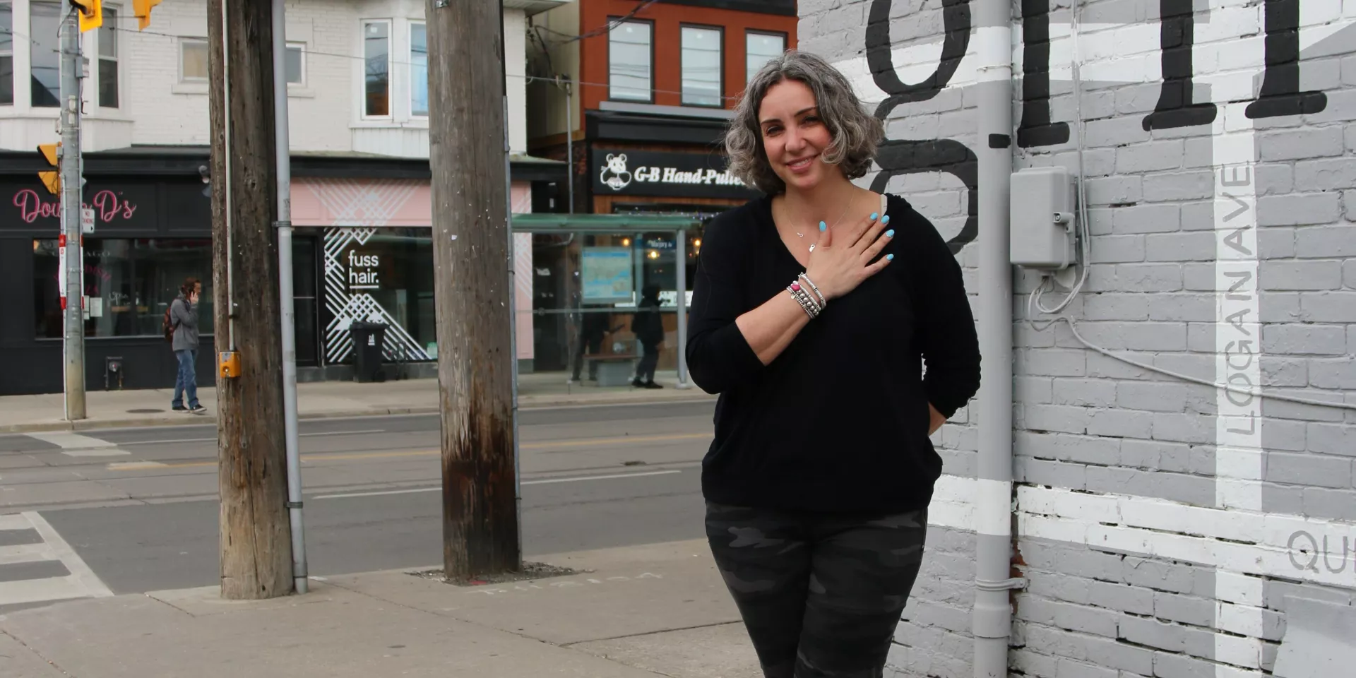 Joelle Murray owner Grinder Coffee woman standing in front of coffee shop