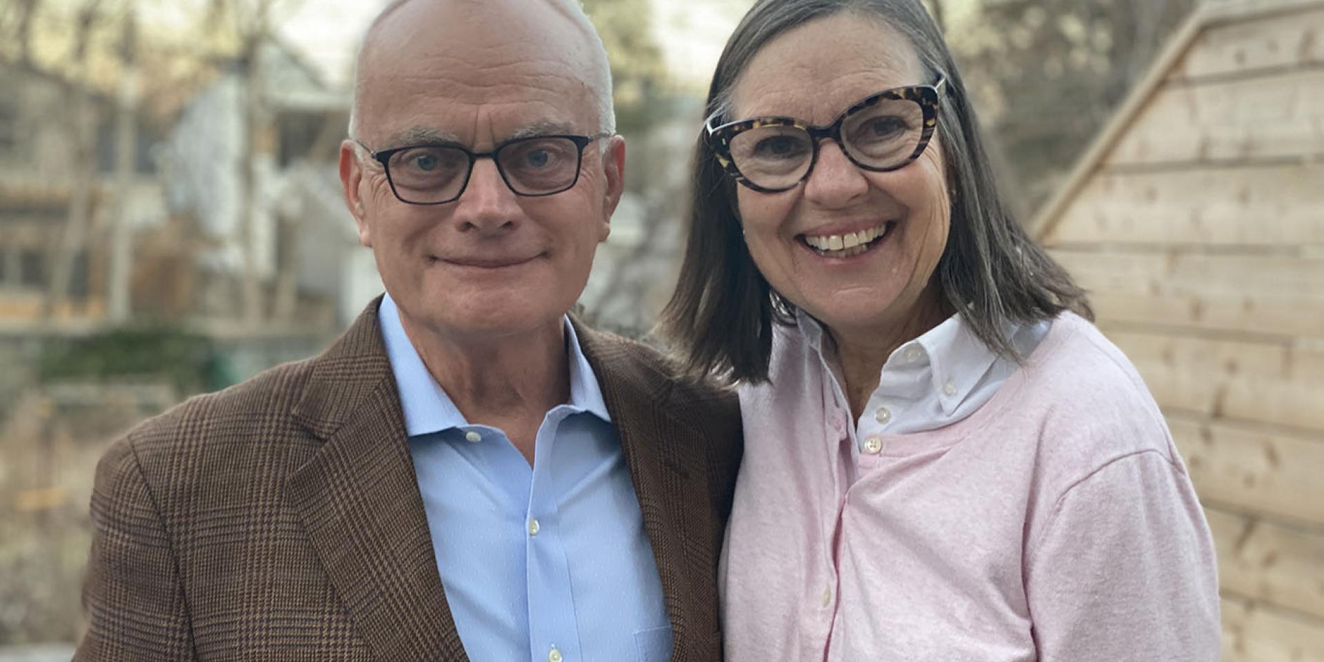 Image of Jack Gibbons and his wife Mary Lovett smiling outside. 