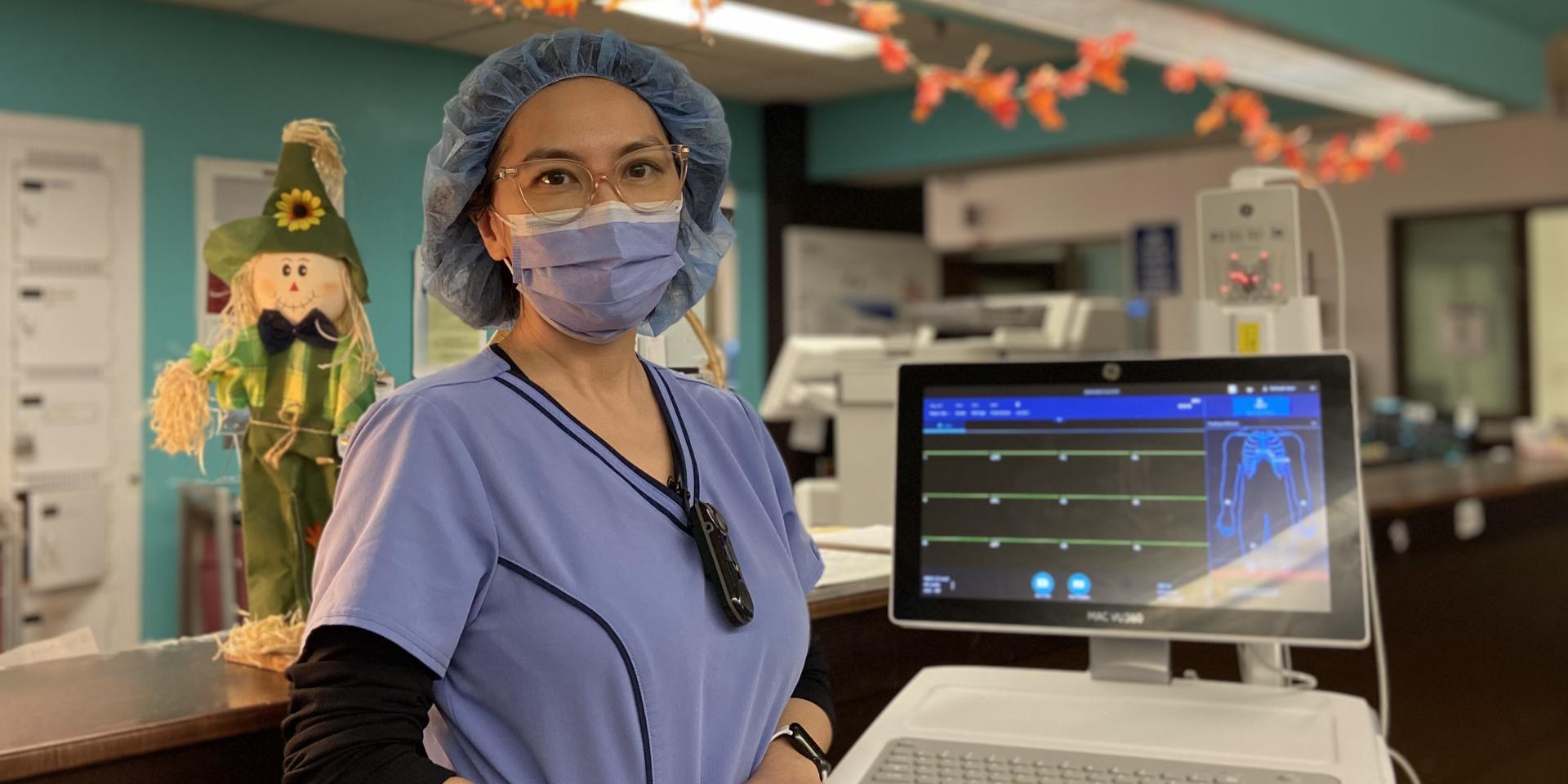 Wei Wei, Registered Nurse in our Cardiology Integrated Unit, stands with one of our new electrocardiogram machines.