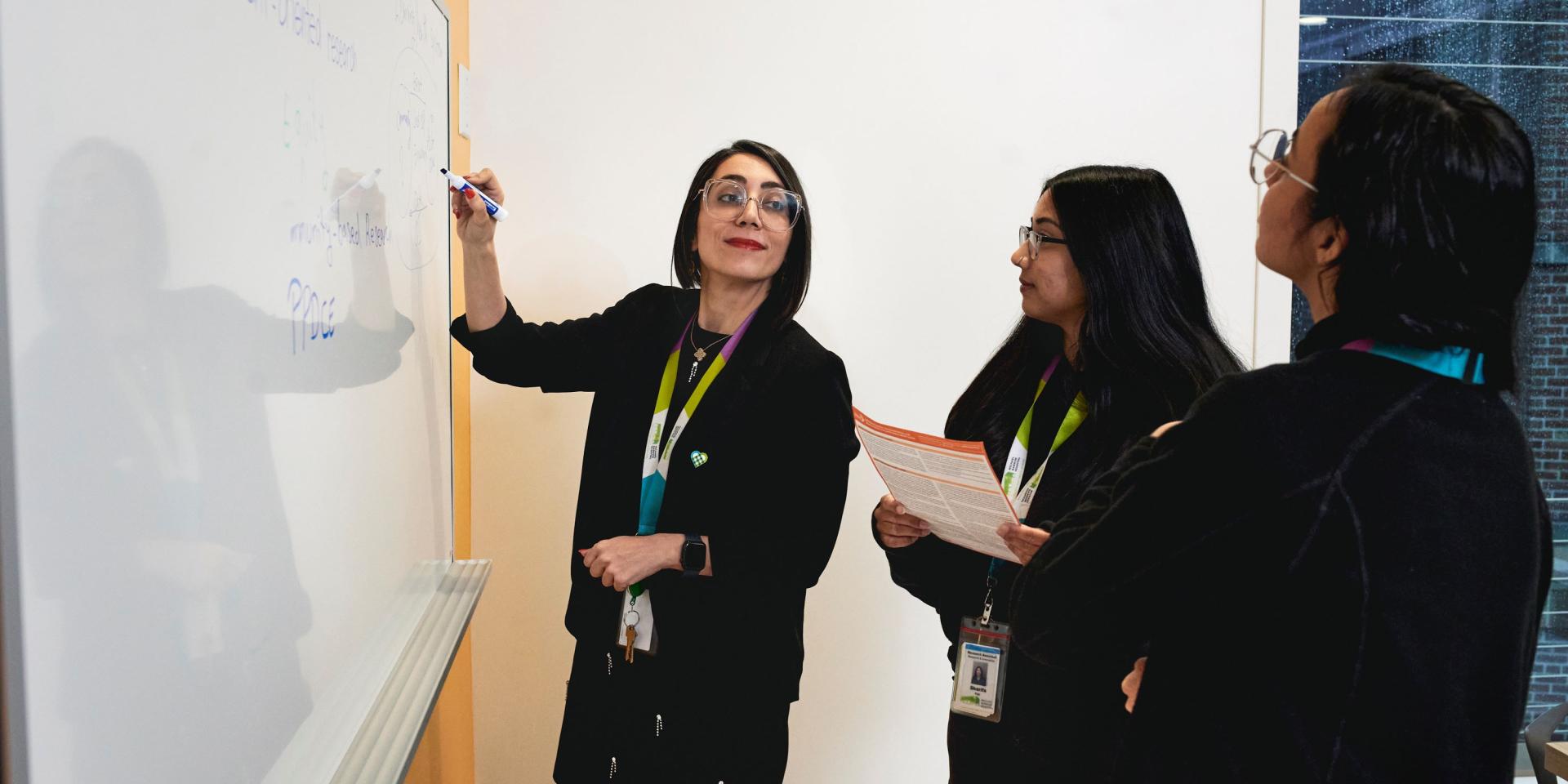 Sara Shearkhani, PhD, Evaluation & Equity Scientist with Michael Garron Hospital and East Toronto Health Partners, collaborates with her team.