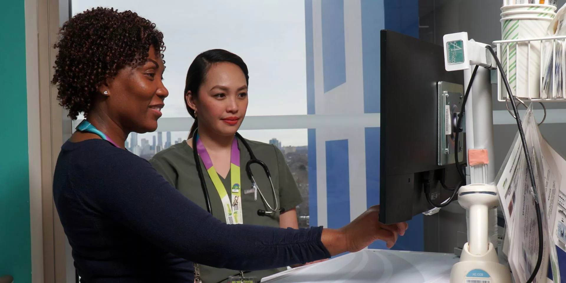 Supervisor Ann Marie Palmer and Registered Nurse Gwynn Fernandez collaborating on patient care.