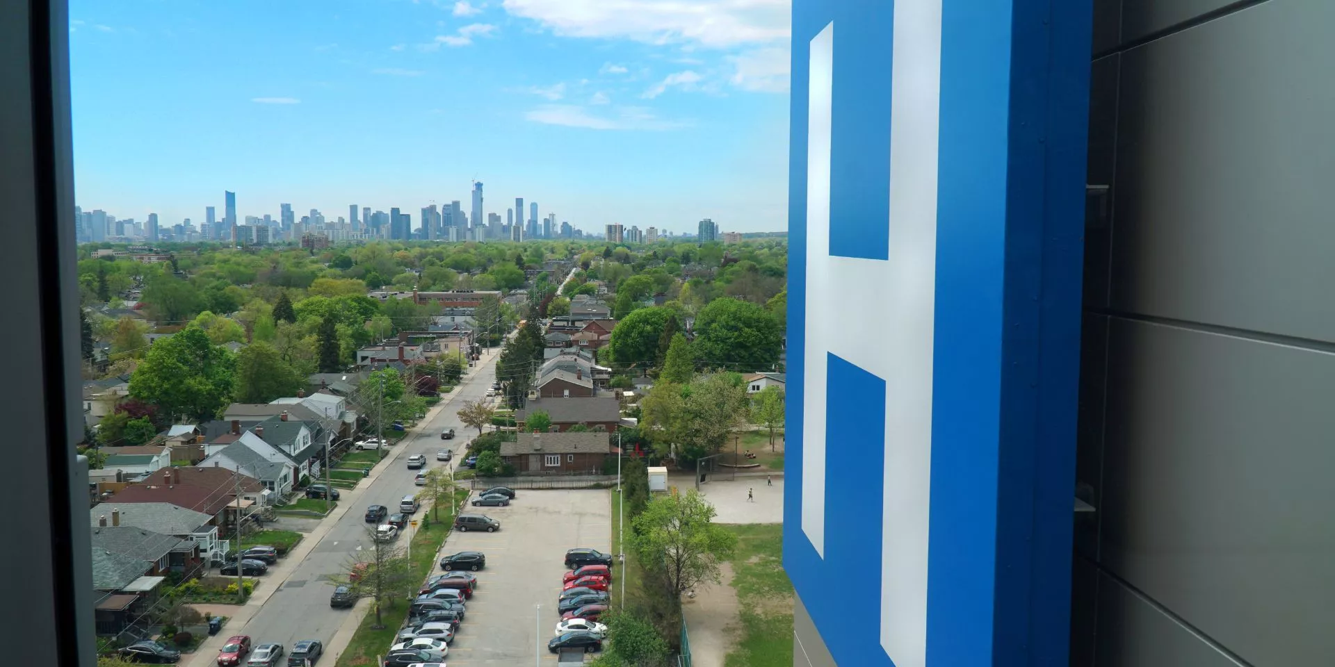 Blue "H" sign overlooking the neighbourhood around the hospital