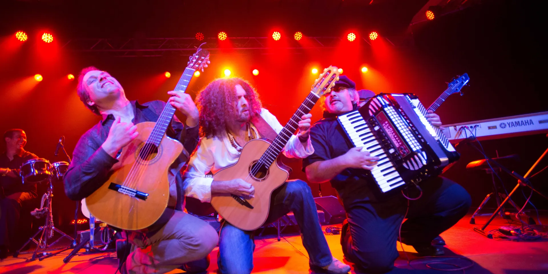 Three performers on stage