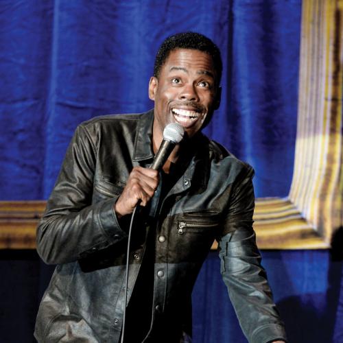 Chris Rock talking into microphone