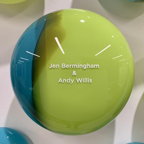 Blue and green handblown glass orb engraved with the names Jennifer Bermingham and Andy Willis