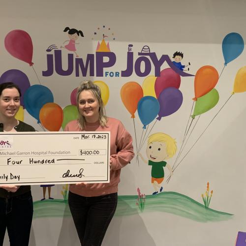Jump for Joy play centre presenting MGHF a cheque for community funds raised