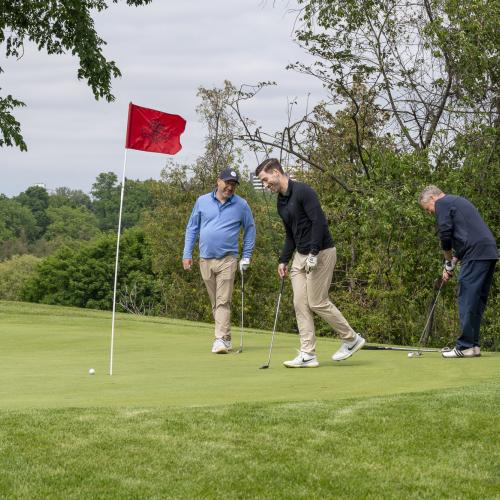 Four golfers on green