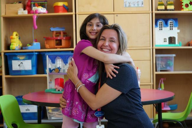 woman hugging little girl