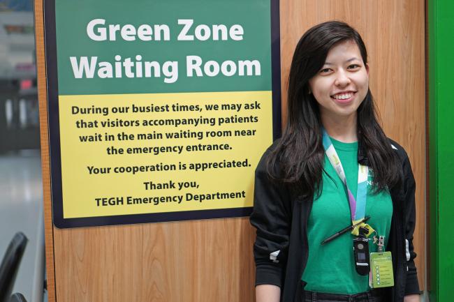 Woman standing in front of sign 