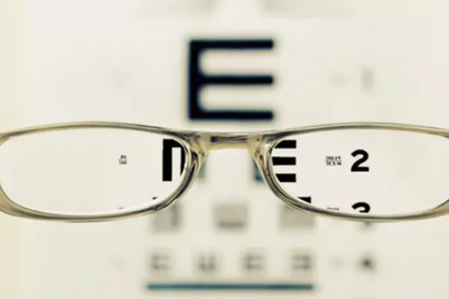 eyeglasses in front of eye chart