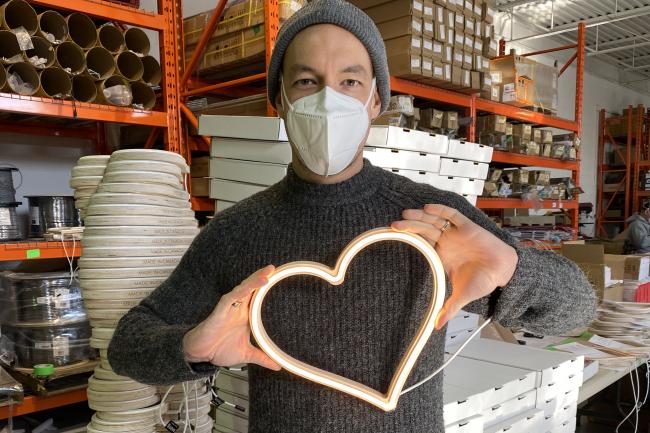 man holding LED heart