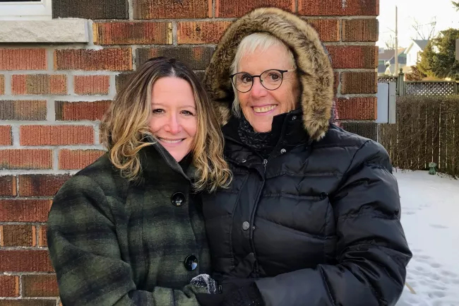 two woman standing outside 