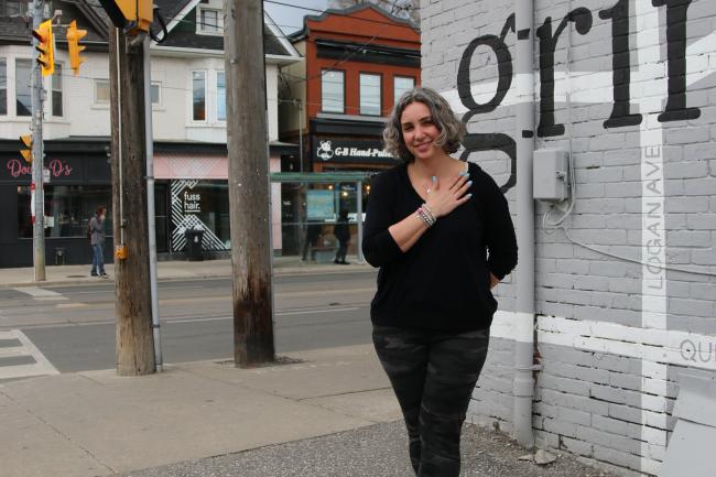 woman standing in front of coffee shop 