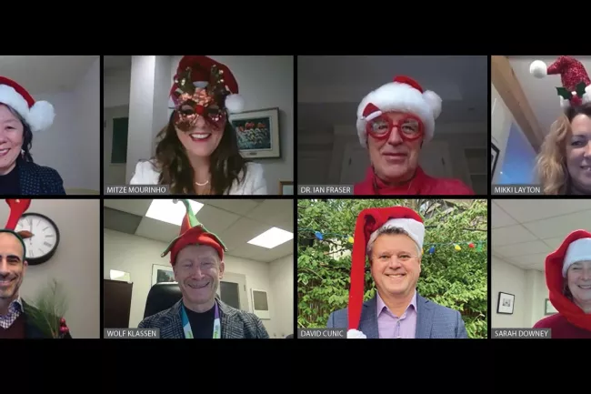 executive team all wearing holiday hats 