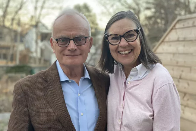Jack Gibbons with his wife, Mary Lovett. (Photo credit: Josh Clavir) Image of Jack Gibbons and his wife Mary Lovett smiling outside.