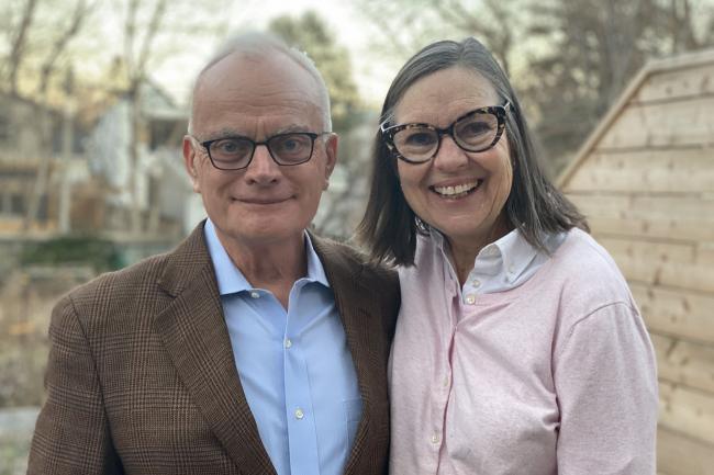 Image of Jack Gibbons and his wife Mary Lovett smiling outside. 