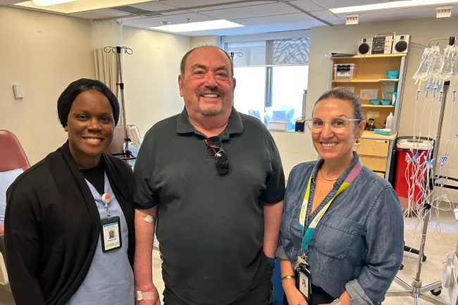 Dan stands with nurse Natasha Beason and haematologist Dr. Patricia Disperati 