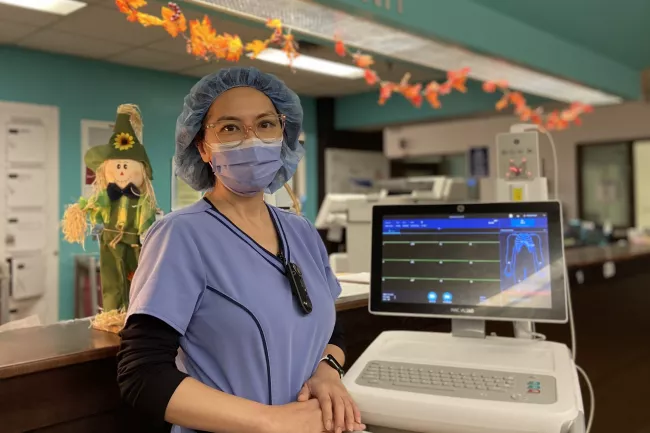 Wei Wei, Registered Nurse in our Cardiology Integrated Unit, stands with one of our new electrocardiogram machines.