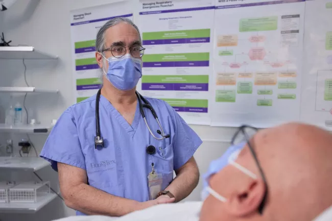 Dr. David Rosenstein, Information Technology Lead in our Stavro Emergency Department sees to a patient.