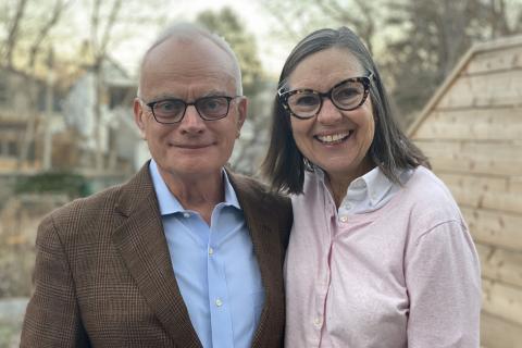 Image of Jack Gibbons and his wife Mary Lovett smiling outside. 