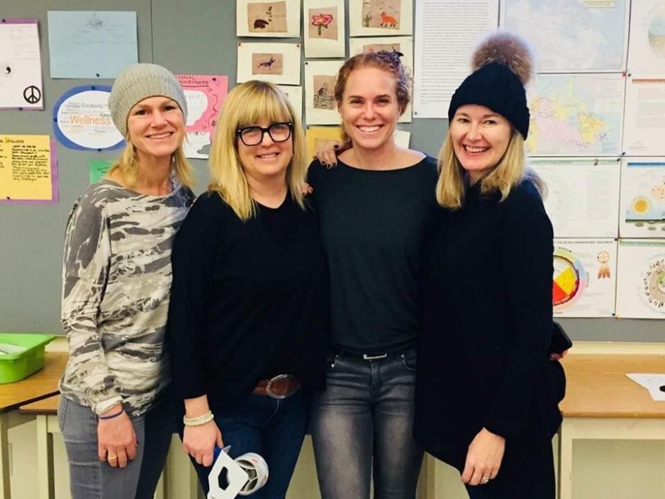 Four women standing facing the camera 